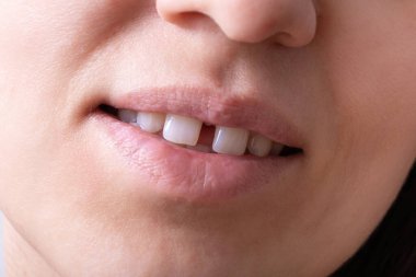 Close up of woman's open smiling mouth with gap teeht. Lips and unusual teeth. clipart