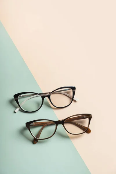 Stylish eyeglasses on colored background. Optical store, vision test, stylish glasses concept