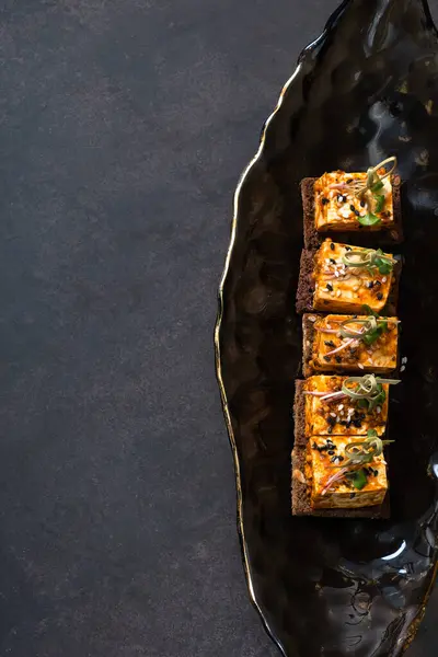 stock image Sandwiches with pickled soft cheese on dark background.