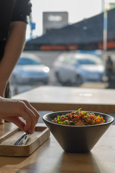 stock image Bowl with tasty rice, meat and vegetables on interior cafe background