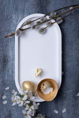 Easter composition with flowers, white rabbit and eggs flat lay, top view. Blank Easter greeting card