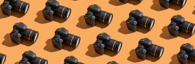 Pattern from many photo cameras on colored background. World Photography Day concept.