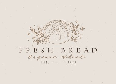 Bej arkaplana işlenmiş organik buğday ve çiçek aranjmanlı çiftlik ekmeği.