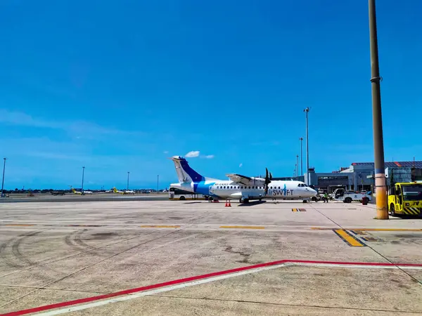 stock image Cebu, Philippines - March 13, 2024: Ground crew starts work on the plane of Air Swift Airline that just landed on the province.