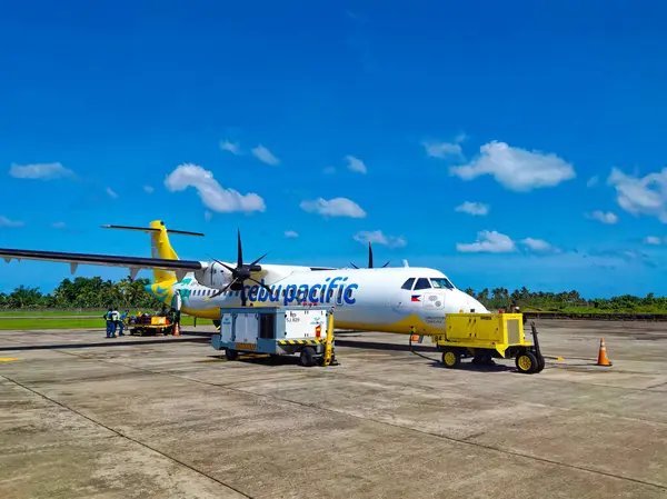 stock image Siargao, Surigao, Philippines - March 13, 2024: Ground crew starts work on the plane of Cebu Pacific Airline that just landed on the island.