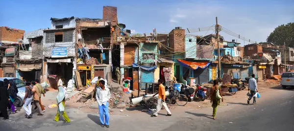 stock image Delhi, India - April 08, 2012: Panoramic view of a section of slum houses and residents in Old Delhi.