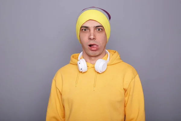 Portrait Childish Palyful Man Wearing Yellow Hoodie Beanie Hat Headphones — Φωτογραφία Αρχείου