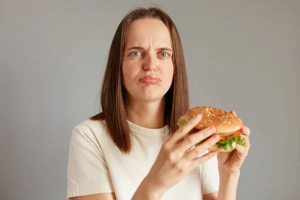 Indoor Shot Upset Woman Wearing White Shirt Holding Sandwich Isolated — Stock Photo, Image