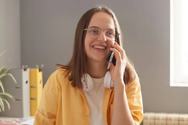 Indoor Shot Cheerful Woman Wearing Yellow Shirt Talking Cell Phone — Stock Photo, Image