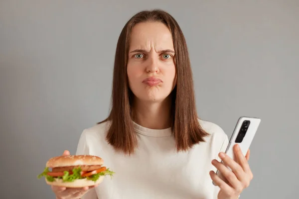 Portrait Sad Upset Young Woman Dark Hair Holding Burger Mobile — Stock Photo, Image