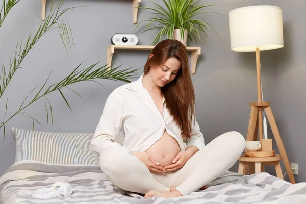 Winsome Adorable Pregnant Woman Touching Her Bare Belly Wearing White — Stock Photo, Image