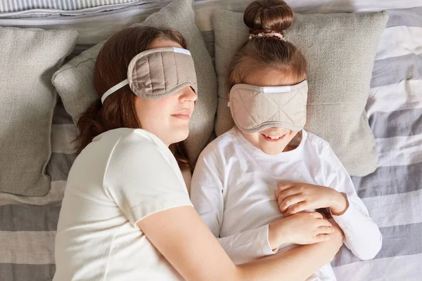 Top View Mother Lying Pillow Daughter Wearing Blindfolds Resting Morning — Stock Photo, Image