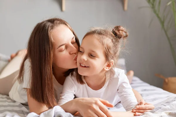 Portrait Smiling Cute Little Girl Lying Bed Mother Woman Kissing — Stock Photo, Image