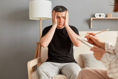 Baş ağrısı ve ruhsal sorunları olan umutsuz bir adam psikoterapi ofisinde oturup dertlerinin derin bir depresyonda olduğunu ve üzüntü ve üzüntü ifade ettiğini anlatıyor..