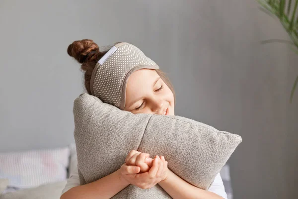 Satisfied Delighted Cute Girl Embracing Pillow Wearing Blindfold Sitting Closed — Stock Photo, Image
