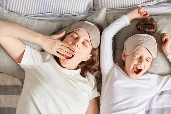 Sleepy Mother Daughter Sleeping Together Waking Wearing Sleep Masks White — Stock Photo, Image