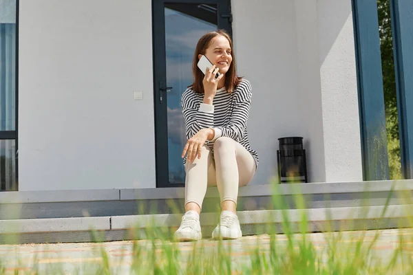 Young Adult Girl Sitting Porch Home Speaking Mobile Phone Smiles — Stock Photo, Image