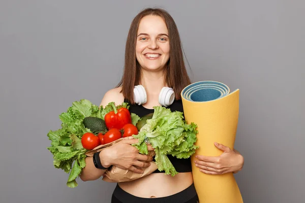 Friska Nöjda Kaukasiska Kvinna Som Håller Organiska Grönsaker Och Yogamatta — Stockfoto
