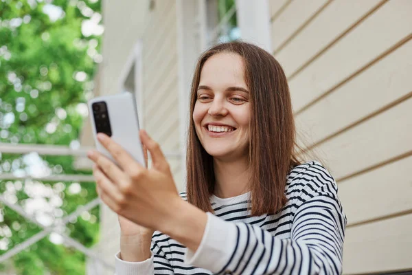 Cheerful Caucasian Attractive Adult Woman Wearing Striped Shirt Using Phone — Stock Photo, Image