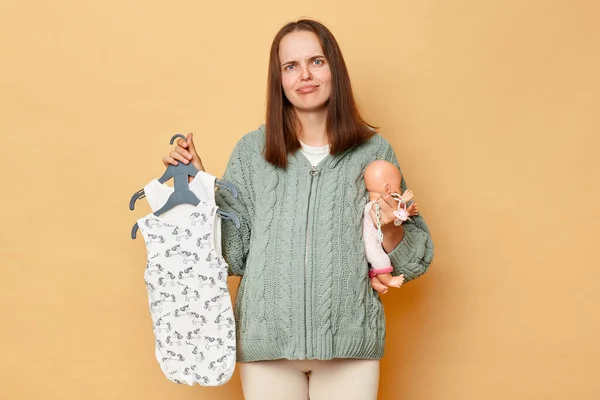Sad Unhappy Young Pregnant Woman Baby Bodysuits Isolated Beige Background — Stock Photo, Image