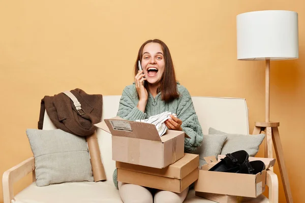 Happy Laughing Woman Sitting Sofa Boxes Clothing Talking Mobile Phone — Stock Photo, Image