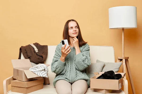 Pensive Woman Wearing Knitted Sweater Ordered Clothes Boxes Sitting Home — Stock Photo, Image