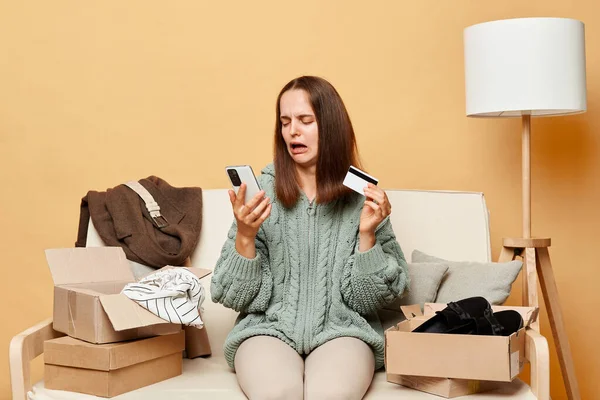 Shocked Woman Wearing Knitted Sweater Ordered Clothes Boxes Sitting Home — Stock Photo, Image