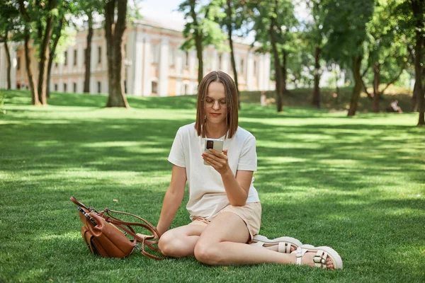 Portrait Attractive Cheerful Girl Wearing Shirt Short Sitting Grass Using — Stock Photo, Image