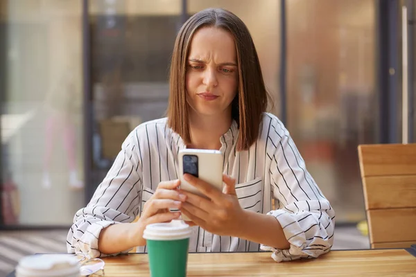 Puzzled Woman Wearing Striped Shirt Sitting Cafe While Having Break — Stock Photo, Image