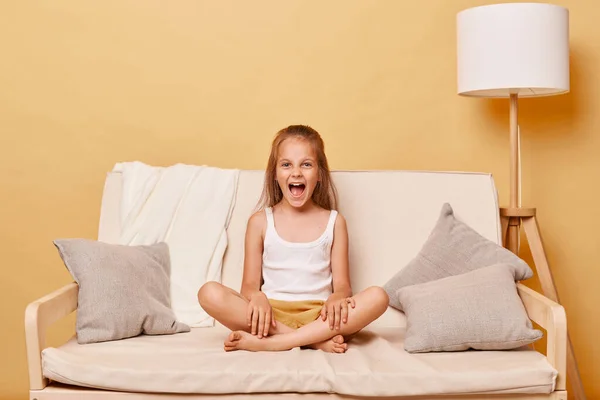 Angry Little Girl Wearing Casual Clothing Sitting Sofa Home Beige — Stock Photo, Image