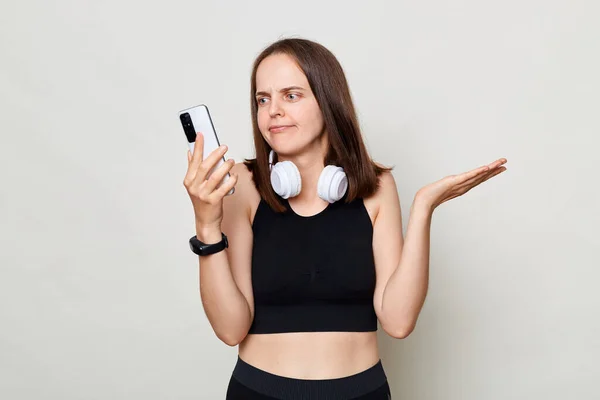 Verwirrte Schlanke Frau Mit Kopfhörer Posiert Vor Grauem Hintergrund Mit — Stockfoto