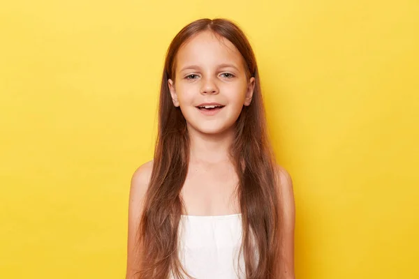 Positive Optimistic Little Girl Long Hair Standing Isolated Yellow Background — Stock Photo, Image