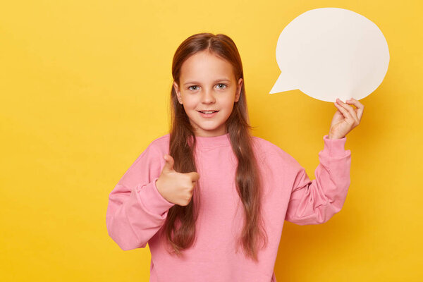 Your message's canvas. Thoughts in progress. Unwritten dialogue space. little kid girl wearing pink sweatshirt isolated over yellow background holding empty speech bubble showing like gesture