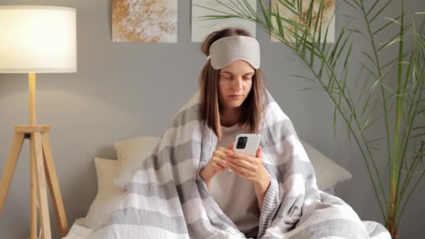 Young Woman Wearing Sleep Eye Mask Wrapped Duvet Blanket Holding — Stock Video