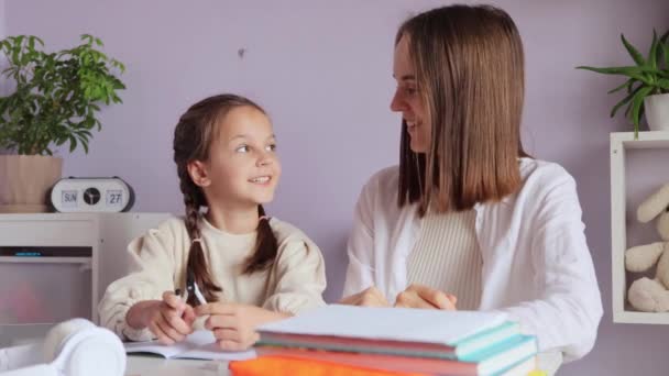 Smiling Little Girl Pigtails Doing Schoolwork Mother Help Home Interior — Stock Video