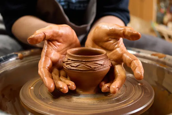 Art workshop. Wet clay. Handcrafted bowl. Ceramic art. Handmade pottery. Creative master. Master potter working in workshop creating clay pot.