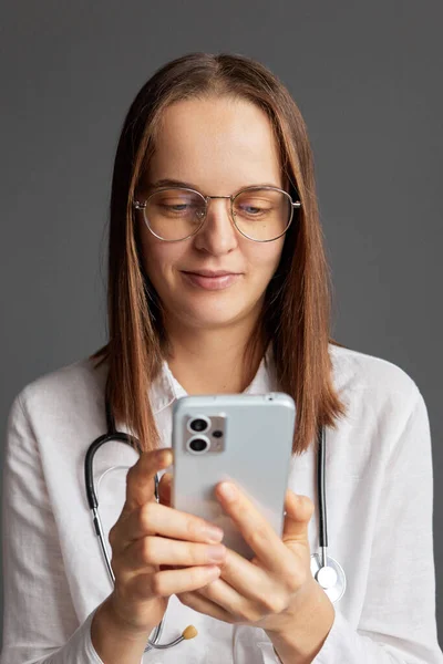 Distance healthcare support. Caucasian woman doctor wearing white medical lab coat stethoscope and glasses having remote consultation with patient answering question in medical forum.