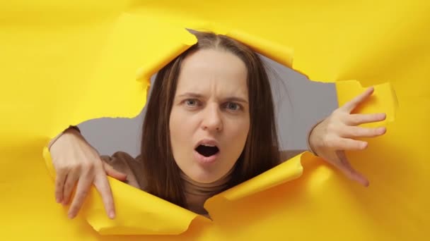 Despair Confused Shocked Brown Haired Woman Breaking Yellow Paper Hole — Stock Video