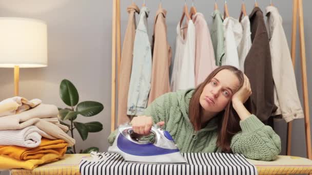 Upset Brown Haired Young Woman Wearing Knitted Shirt Ironing Clothes — Stock Video
