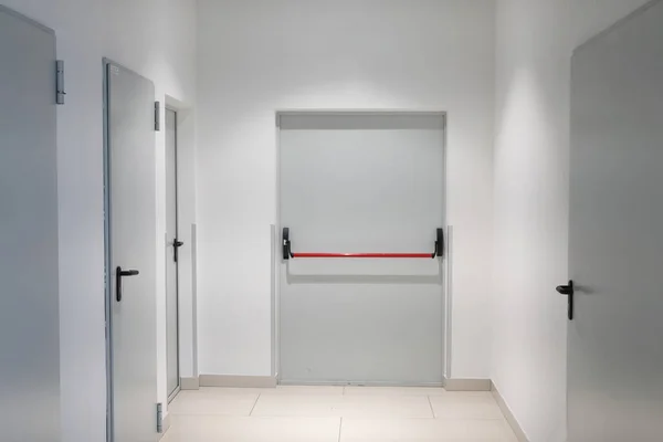Light corridor with iron and steel gray doors basement of modern residential building entrance of residential building with doors in apartment