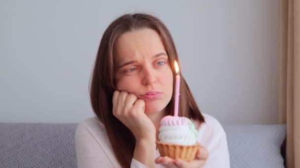 Üzgün Üzgün Bir Kadın Kanepeye Oturmuş Pasta Mumla Kameraya Bakarken — Stok video