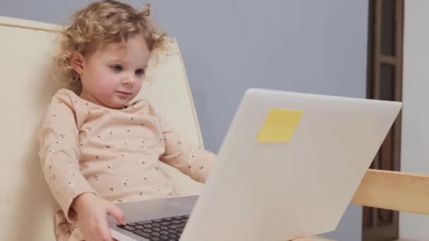 Cute Young Baby Girl Blonde Wavy Hair Playing Laptop Typing — Stock Video