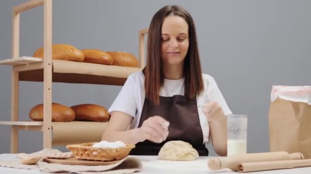 笑顔で陽気でポジティブな魅力的な女性はひざまずき パンを作るための成分を準備する生地に小麦粉 — ストック動画