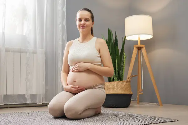 Smiling Pregnant Woman Ponytail Wearing Beige Clothing Sitting Floor Living — Stock Photo, Image