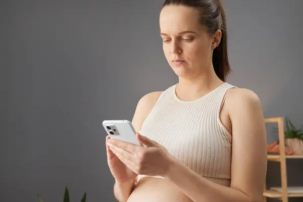Serious Brown Haired Pregnant Woman Beige Top Using Mobile Phone — Stock Photo, Image