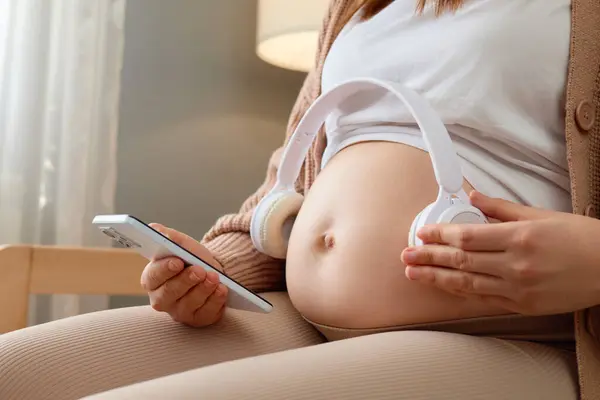Anonymous Unknown Pregnant Woman Holding Headphones Her Big Bare Belly — Stock Photo, Image