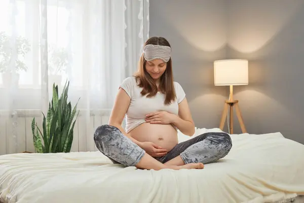 Attractive Brown Haired Pregnant Woman Sitting Bed Lotus Pose Holding — Stock Photo, Image