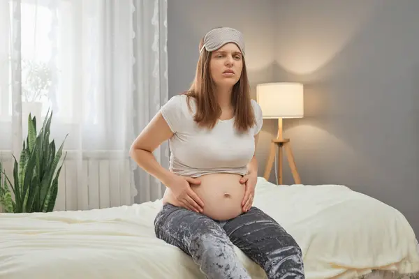 Unhealthy Pregnant Woman Holding Her Belly While Sitting Bed Home — Stock Photo, Image