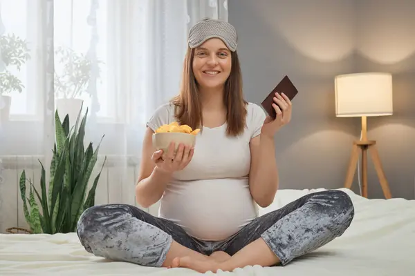 Satisfied Caucasian Pregnant Woman Wearing Pajama Sleeping Mask Sitting Bedroom — Stock Photo, Image
