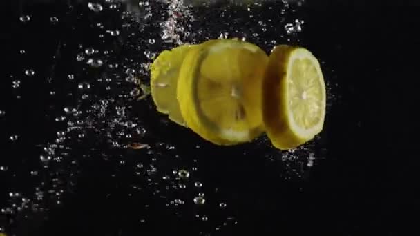 Gruppo Fette Fresche Organiche Limoni Che Cadono Acqua Con Spruzzi — Video Stock